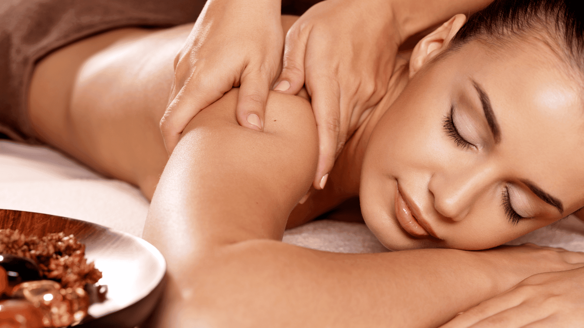 Person receiving a relaxing massage with a focus on arm and shoulder.