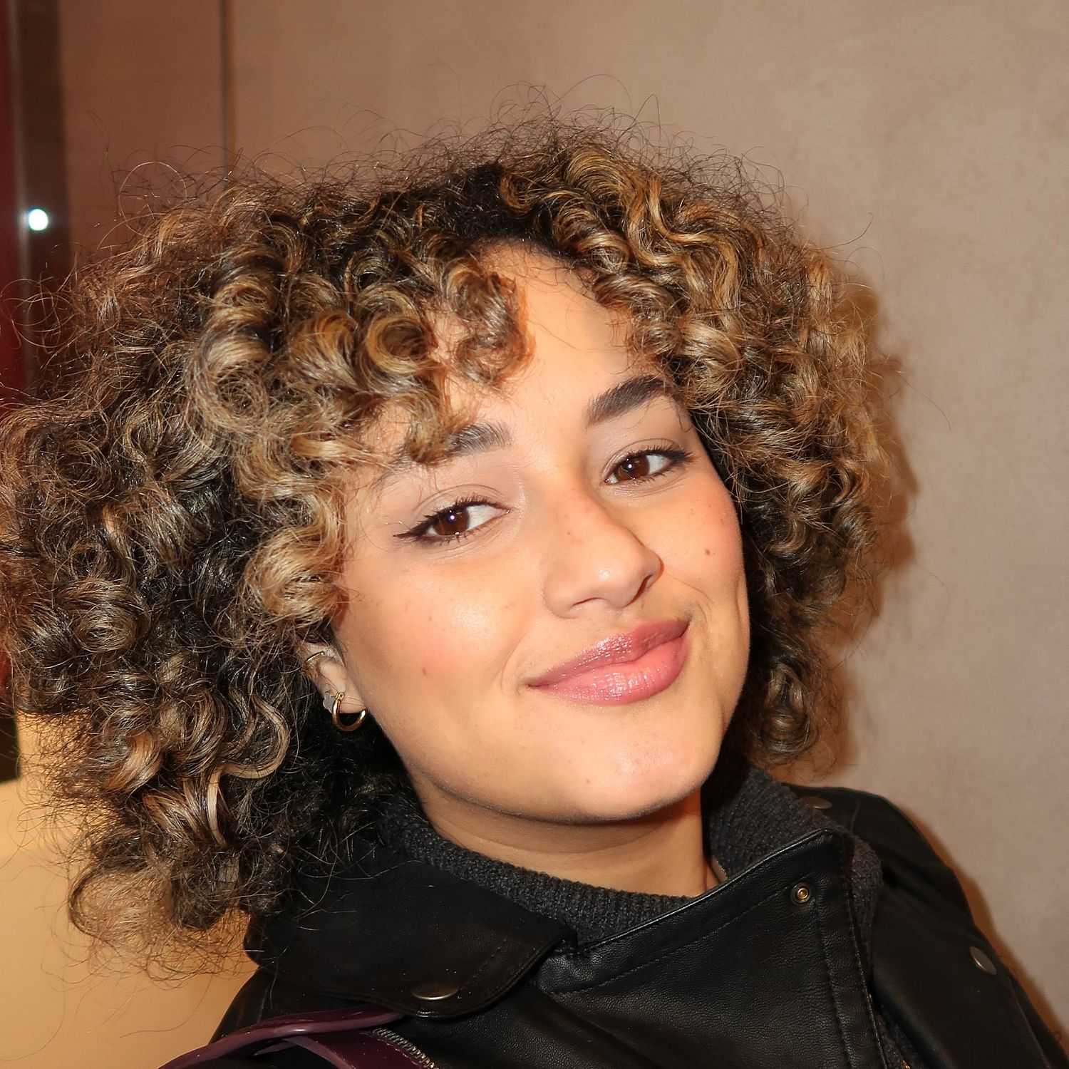 Portrait of Adiela Santiago Rodriquez, a professional stylist at Invidia Salon and Spa, showcasing their expertise and style.