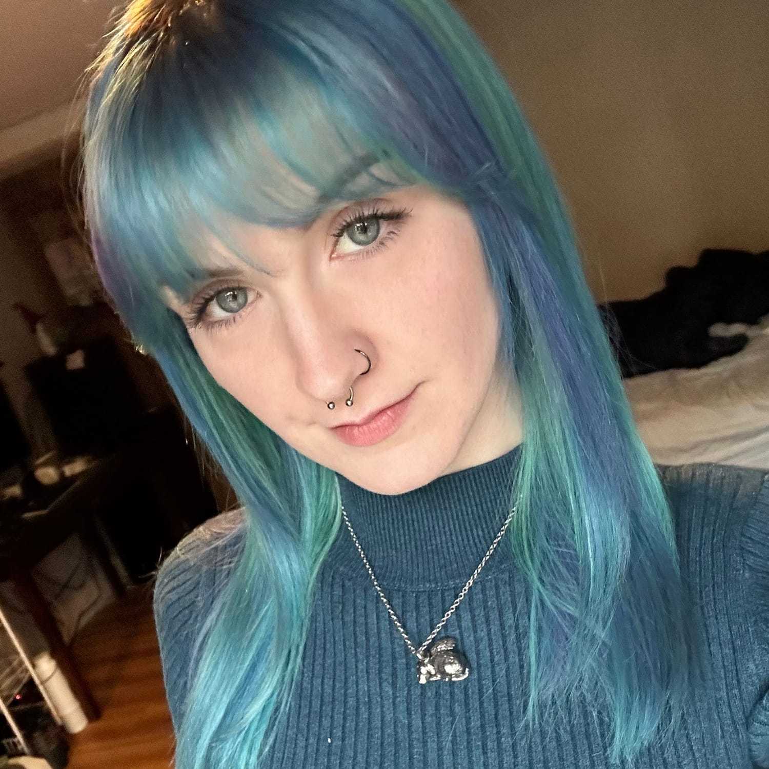 Portrait of Ashley, a professional stylist at Invidia Salon and Spa, showcasing their expertise and style.
