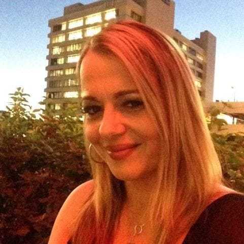 Portrait of India, a professional stylist at Invidia Salon and Spa, showcasing their expertise and style.