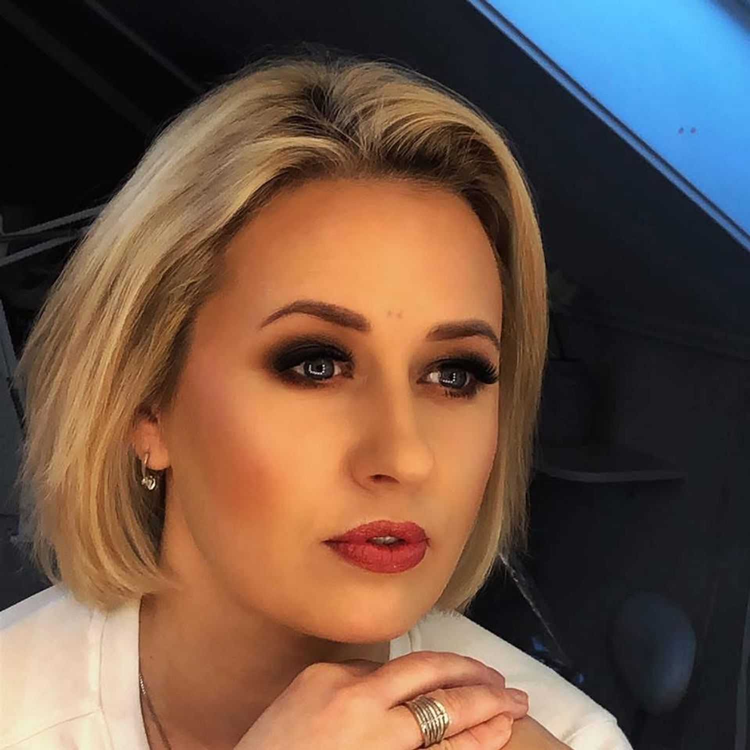 Portrait of Erika Brusoke, a professional stylist at Invidia Salon and Spa, showcasing their expertise and style.