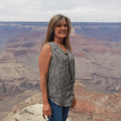 Portrait of Colleen, a professional stylist at Invidia Salon and Spa, showcasing their expertise and style.