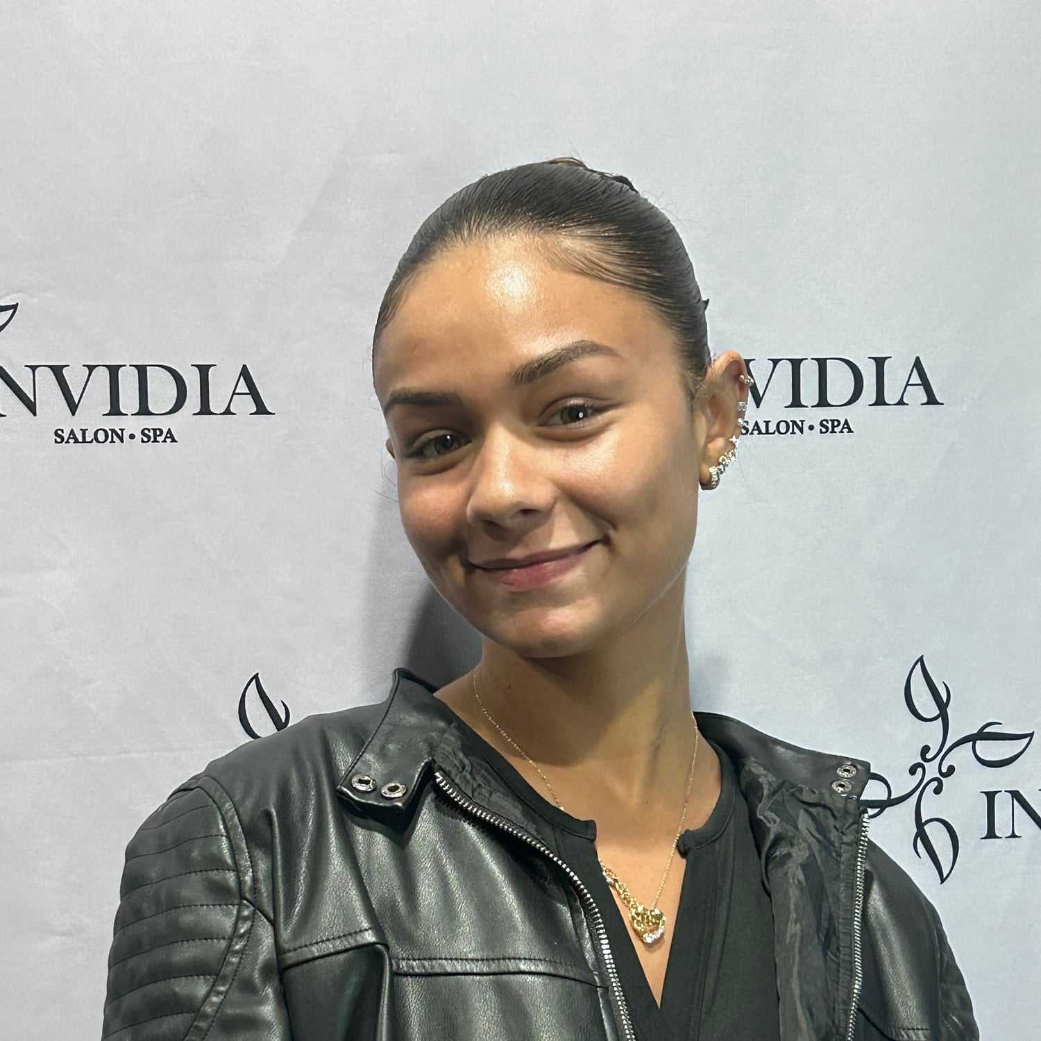 Portrait of Kamylle Alves, a professional stylist at Invidia Salon and Spa, showcasing their expertise and style.